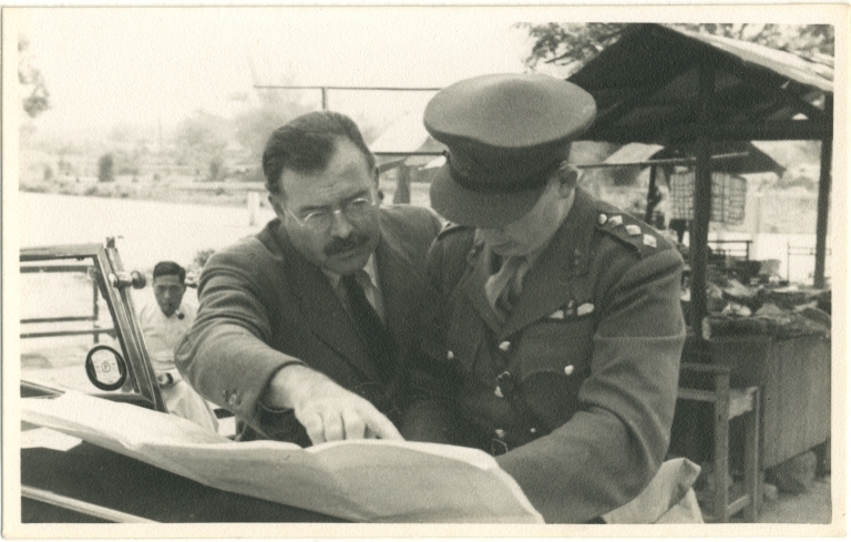 Hemingway Pointing to Document Held by Man in Army Uniform